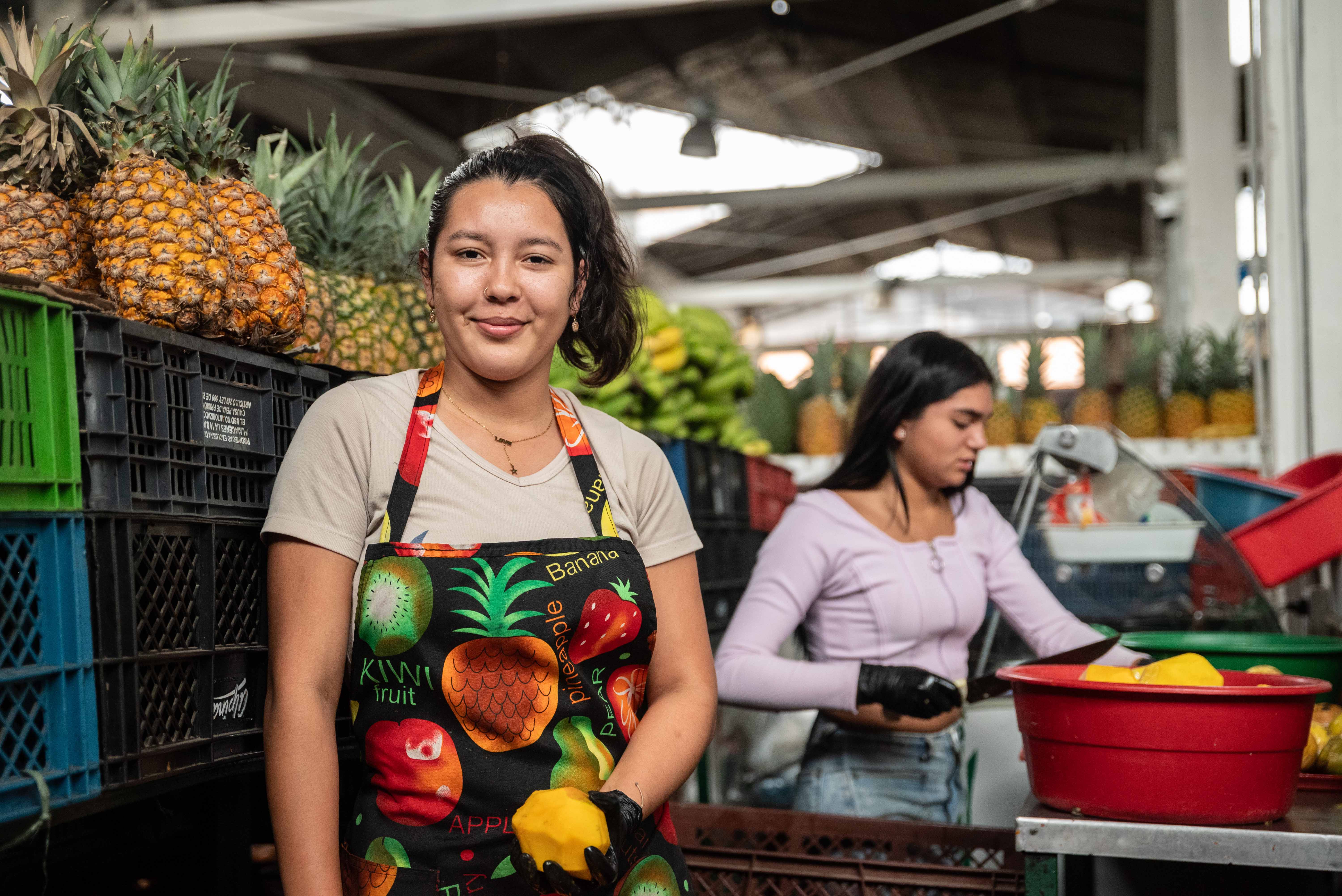 Foto de una pajera de mujeres jóvenes trabajando en la plaza de mercado