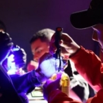 Foto de personas llenando botellas con licor