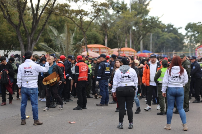 En la fotografía se puede apreciar a tres funcionarias y funcionarios de Diálogo en medio de una manifestación de la ciudadanía.